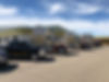 Trucks, cars and bus parked outside