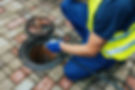 A man cleaning a sewer line.