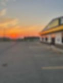 Empty parking lot with a sunset in the background