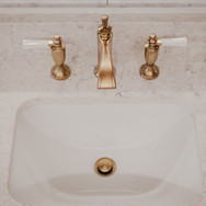 Goledn faucets on a wash basin