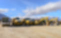 Multiple excavators standing side by side