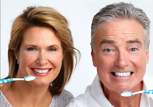 Happy elderly couple with toothbrush.