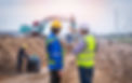 Two workers inspecting a dug out land