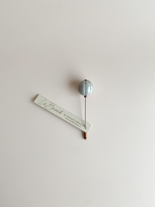 Handcrafted artisanal ceramic brooch with vibrant colors and unique shapes, set on a high-quality sterling silver pin, offering a stylish and elegant accessory