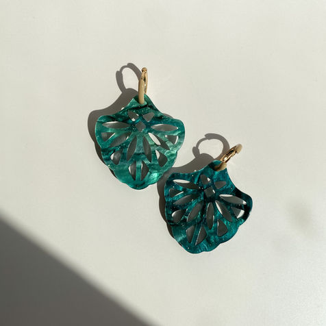 Elegant earrings made from organic resin with beautiful organic and geometric shapes, featuring sterling silver hoops and studs for a stylish and eco-friendly accessory
