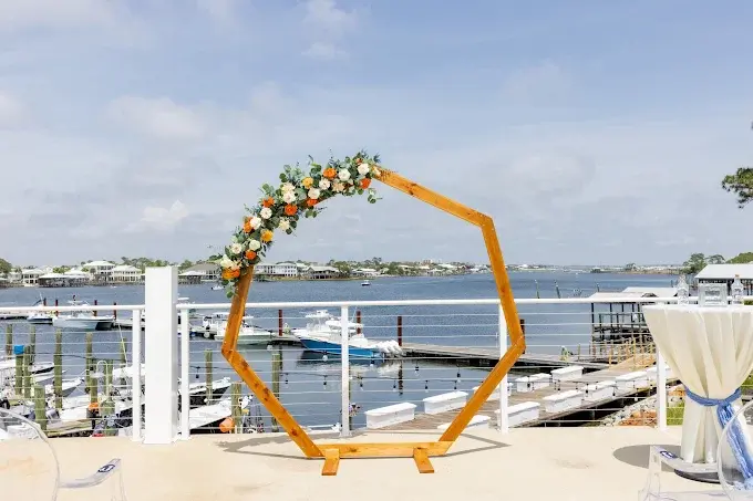 Hexagon wedding arch and venue overview by the marina