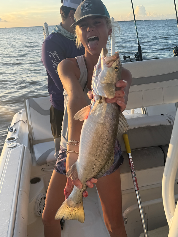 Deckhand Candice Vinson holding a fresh catch on Team Vinson Charters