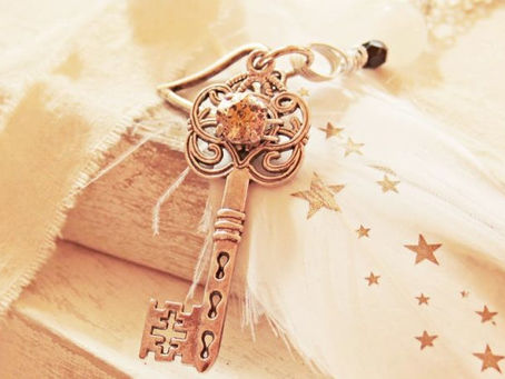 Golden key resting on a natural linen pillow, symbolizing the key factors that support successful therapy