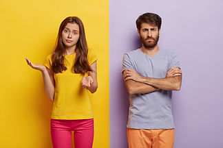 hesitant-young-woman-spreads-hands-with-doubt-wears-casual-clothes-dissatisfied-man-keeps-