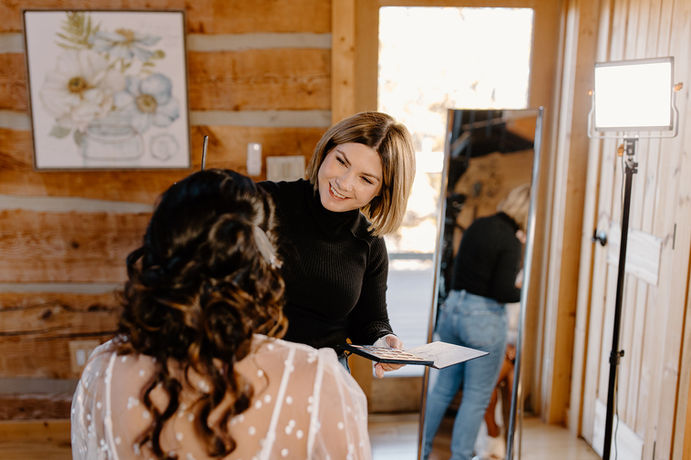 Destination bride receiving makeup at her Sevierville cabin for her wedding day by Rvl'd Beauty.
