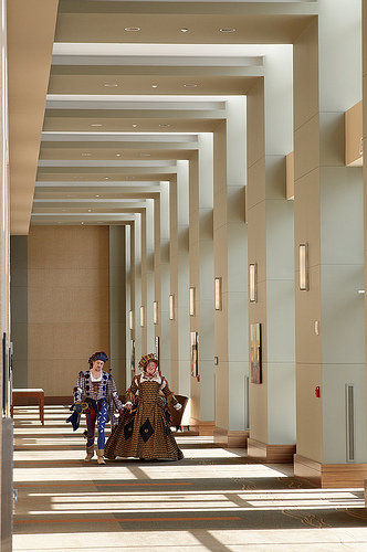 T Stacy Hicks as Monarcho and me as Jane the Phoole, in a hallway at the hotel where Reenactorfest used to happen in the Chicagoland area, in 2010, photo by Ivan Phillips. The composition of the image accidentally mimics the composition of Henri Rousseau's 'Carnival Evening.'