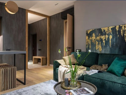 Living room with gray walls and green sofa