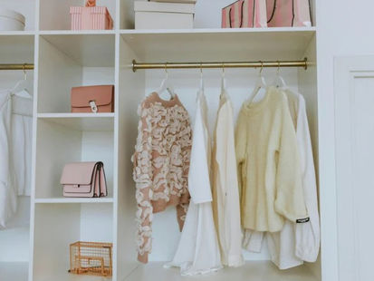 Organized closet with clothes and purses