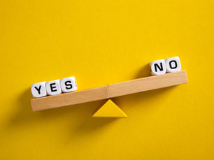 Balance scale with blocks labeled “yes” and “no,” symbolizing evaluating and filtering decisions.
