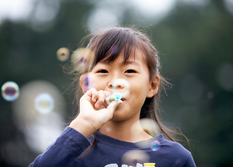 Girl Blowing Bubbles
