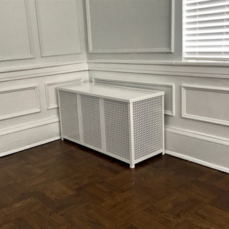 A Barker Metalcraft custom radiator cover in an older building.