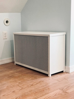 Custom Barker Metalcraft radiator cover installed in a home.
