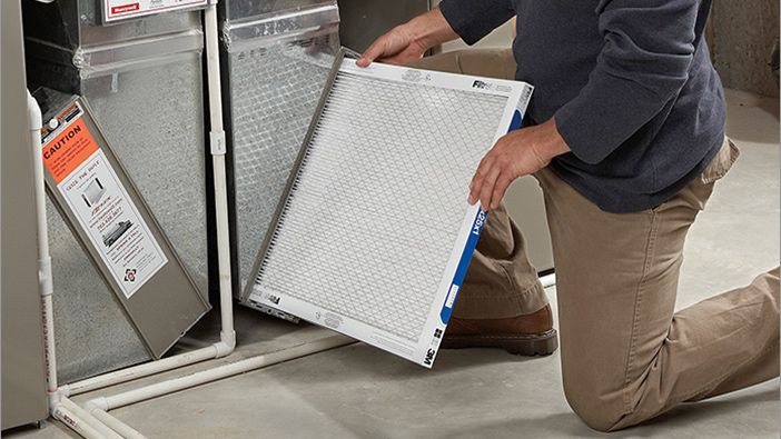 Person installing furnace filter: As a first time home buyer, you'll need to replace your furnace filter every 90 days