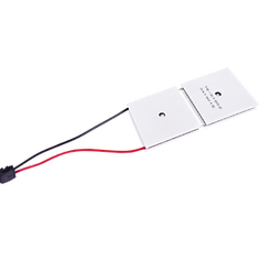 Two square thermoelectric cooling modules with red and black wires.