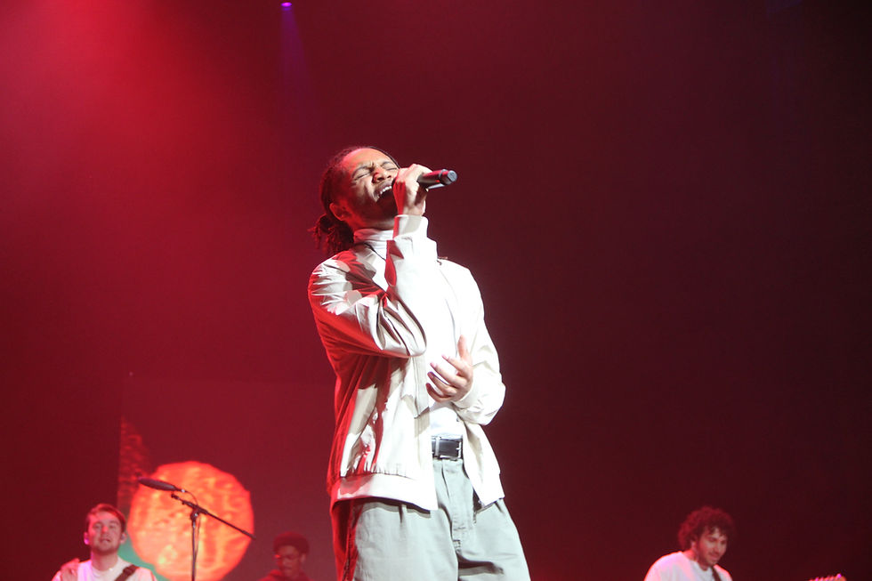 Morman singing out center stage to the crowd, Braden Simmons