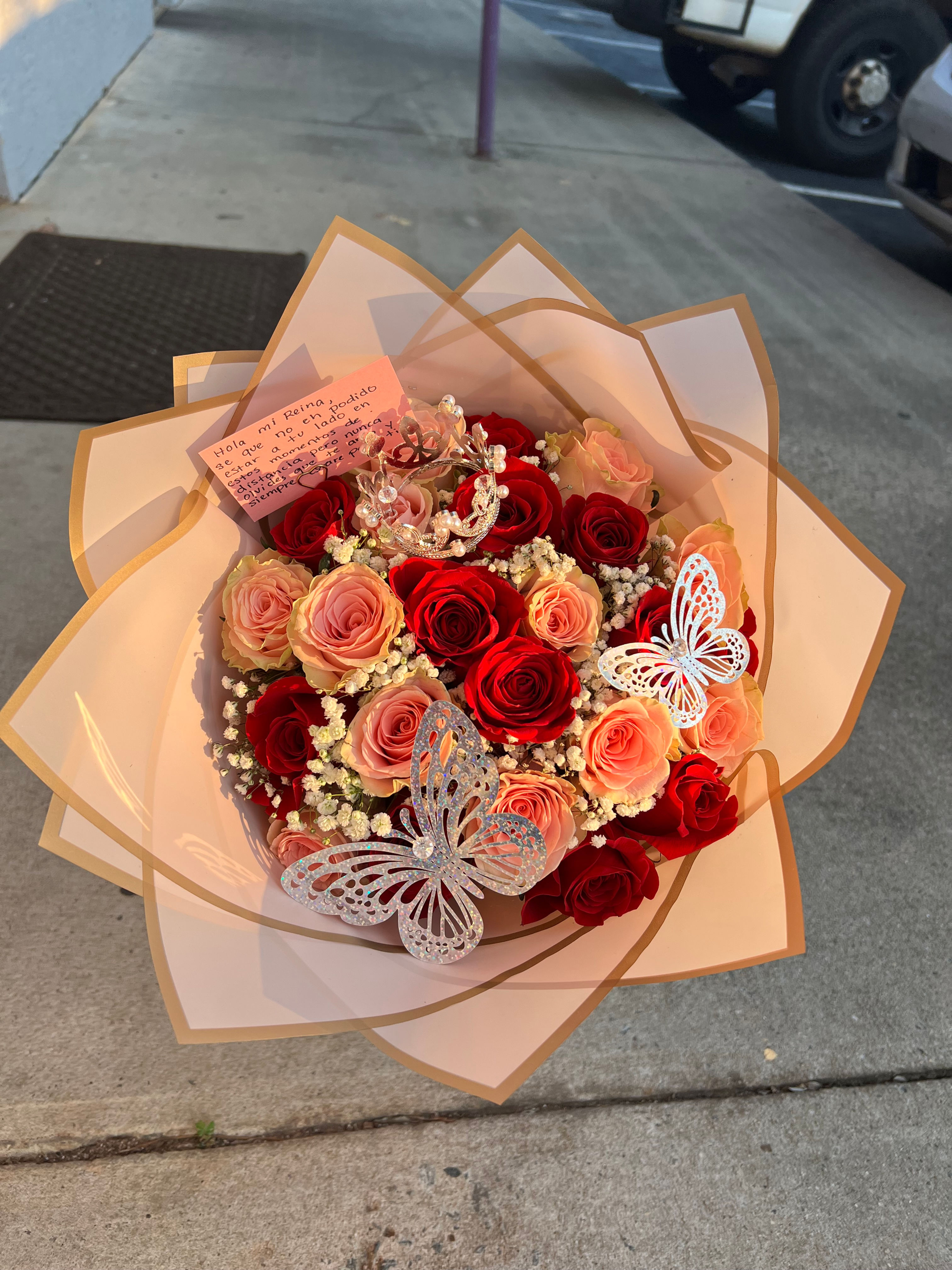 Red and pink rose arrangement with butterfly decoration
