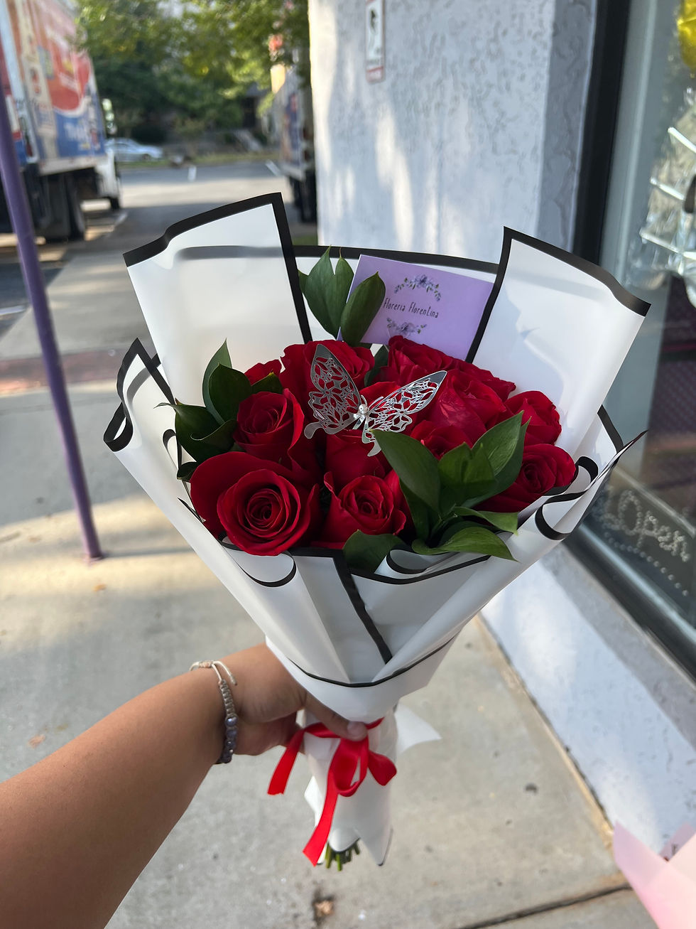 Red rose with a silver butterfly in a bouquet 