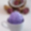Scoop of ube macapuno ice cream, with halved coconut and fresh ube