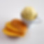 Scoop of mango ice cream surrounded by slices of fresh mango