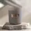 Thumbnail: Mystic Eye Alchemy Candle in signature Eye stone grey vessel with wooden wick.