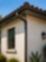 Brown seamless K-style rain gutters professionally installed on a Southern California stucco home