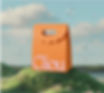 An AI-generated image of an orange bag on a grassy hill, with floating bubbles and a soft sky.