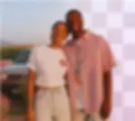 A smiling couple stands outdoors. Half of the background is replaced by a transparent checkerboard pattern to show the background removal tool.