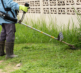 gardening-with-electric-brush-cutter-home-garden-worker-using-cleaner-grass-trimmer-mows-g