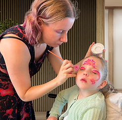 a girl getting face painted