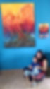 Artist Johanna Jacob Kuruvilla with her son, sitting under her original phoenix painting—capturing the personal roots behind Jo’s Art Space.