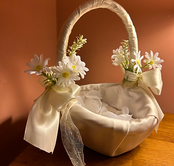Handcrafted satin flower girl basket with white daisies and ribbon bows—charming wedding ceremony decor from Jo’s Art Space.