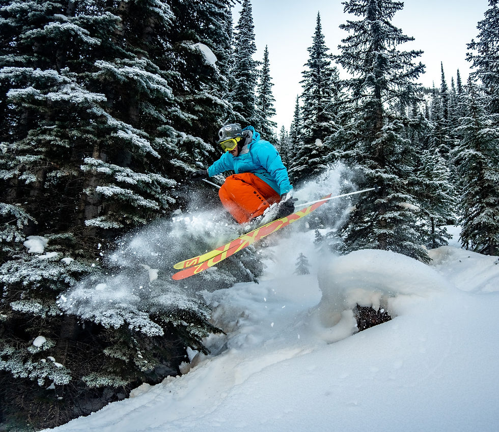 The Founder of Minor Detour Media getting infant of the camera and jumping over a stump during a day of back country skiing in the Columbia Valley