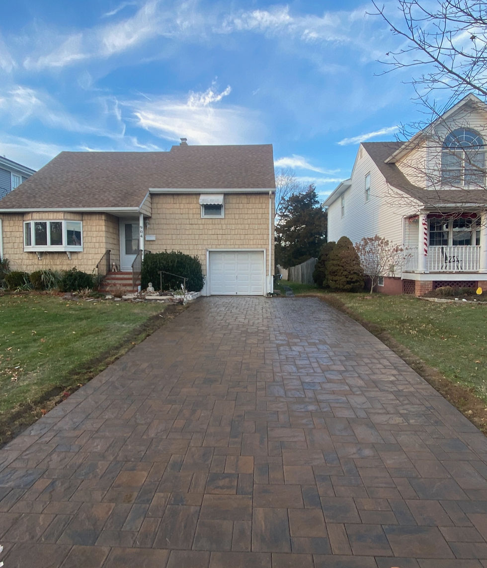 Paver driveway showing landscape transformations.