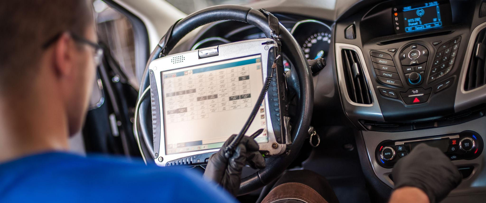 Technician performing engine transmission diagnostics