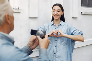 old-man-filming-his-granddaughter.jpg