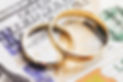 Wedding rings on money. Cost of wedding. Price of getting married background. Golden jewel