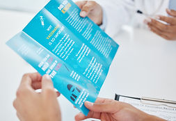Printed brochures, flyers, and business cards neatly arranged to showcase professional business printing services.