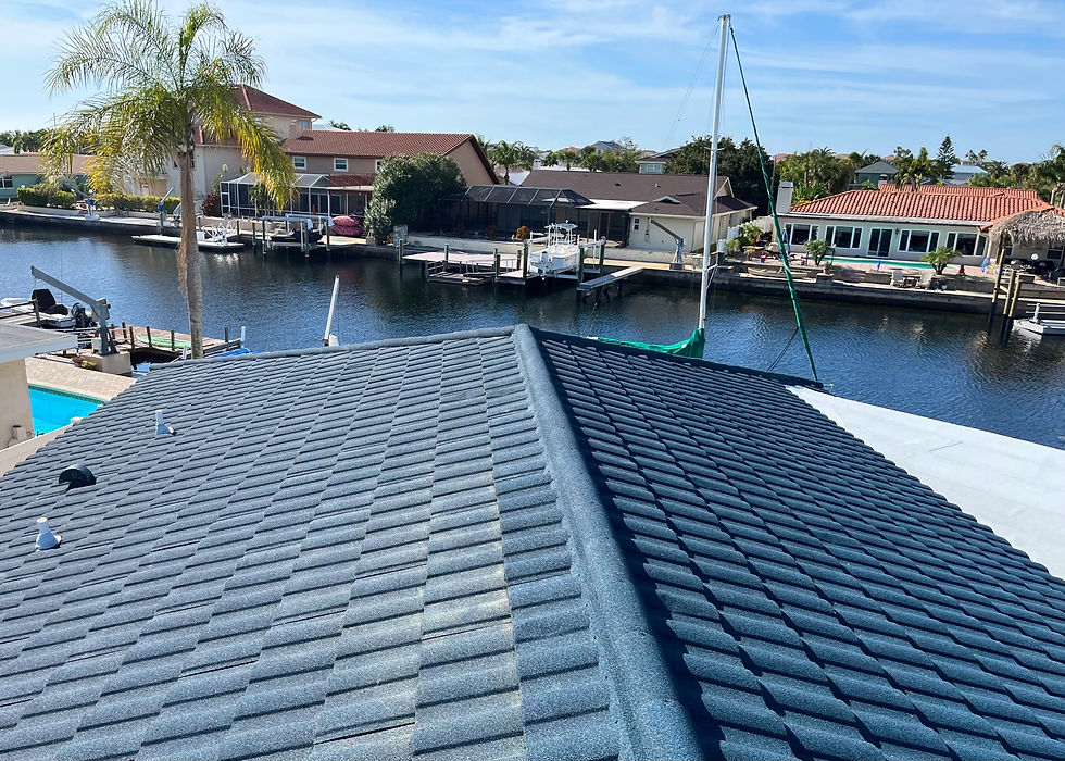 Stone-coated metal roof on a waterfront Florida home overlooking a canal lined with boat docks.