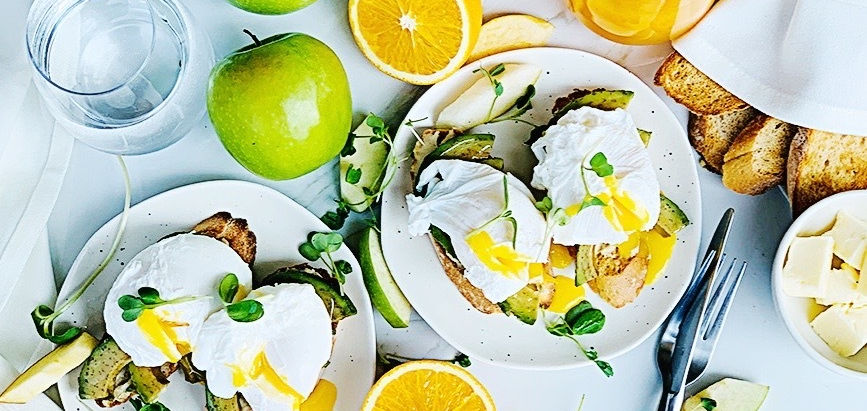 Avocado on toast with hummus and poached eggs
