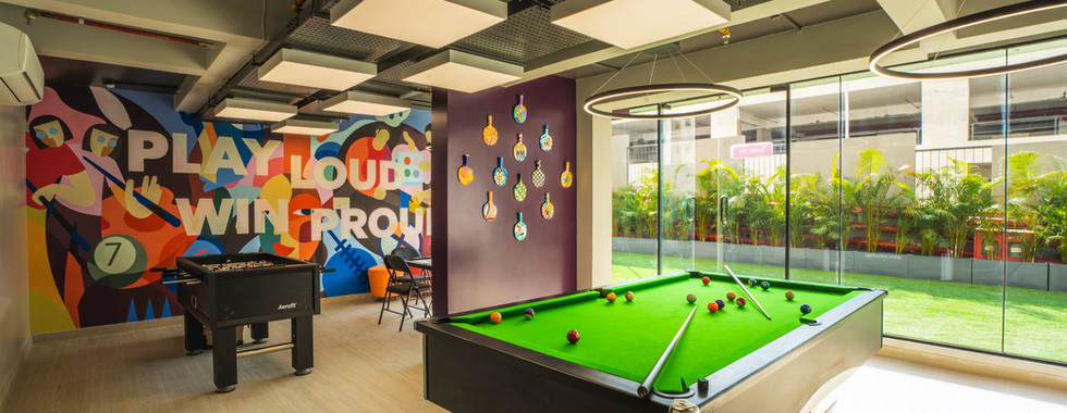 A photo from a Brand photoshoot produced by WolfWorks Ads, featuring the lively game room at YUKIO co-living in Pune. This scene demonstrates our production house's ability to capture dynamic, aspirational content for real estate clients.