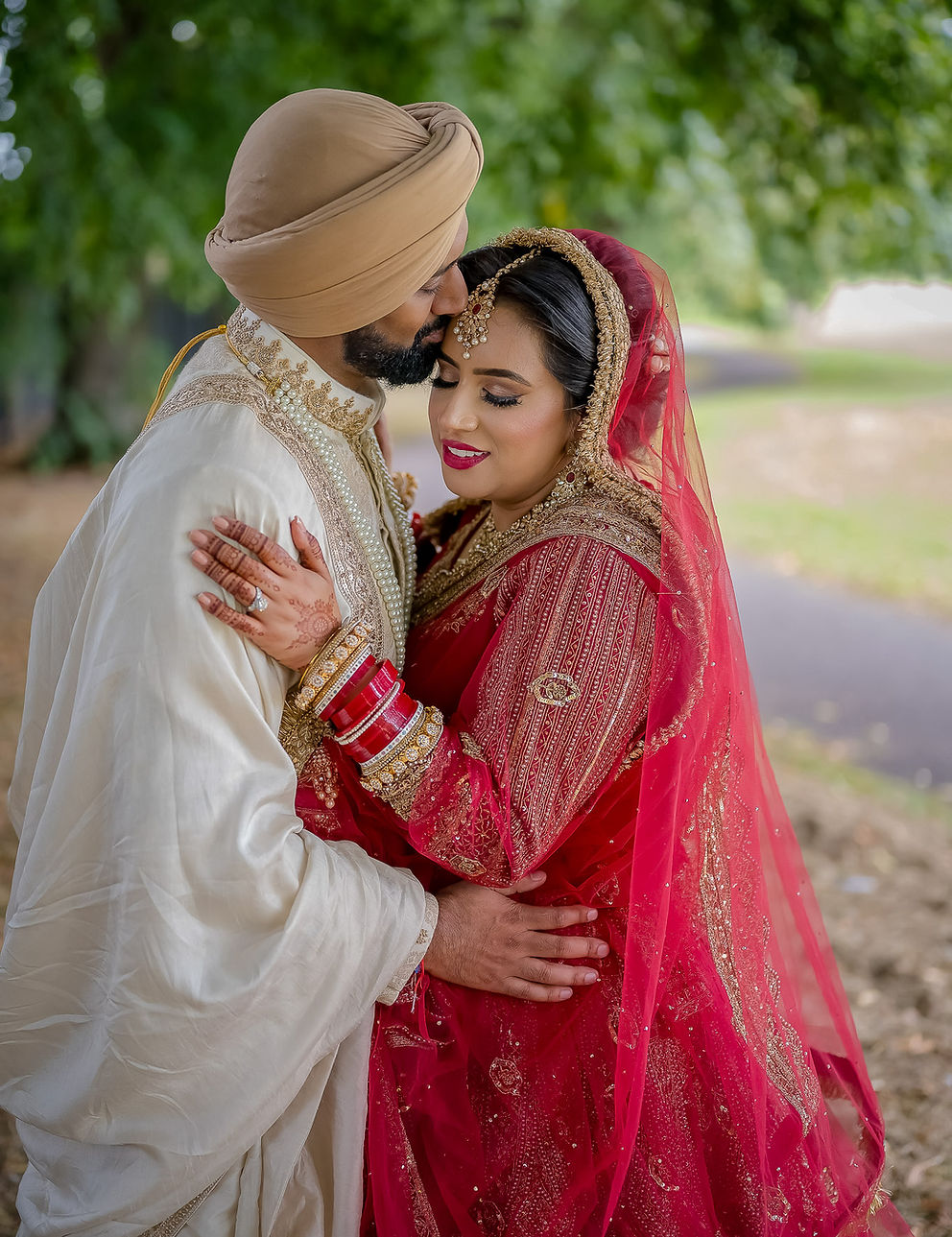Sikh bride and groom outdoor portrait in park, UK wedding