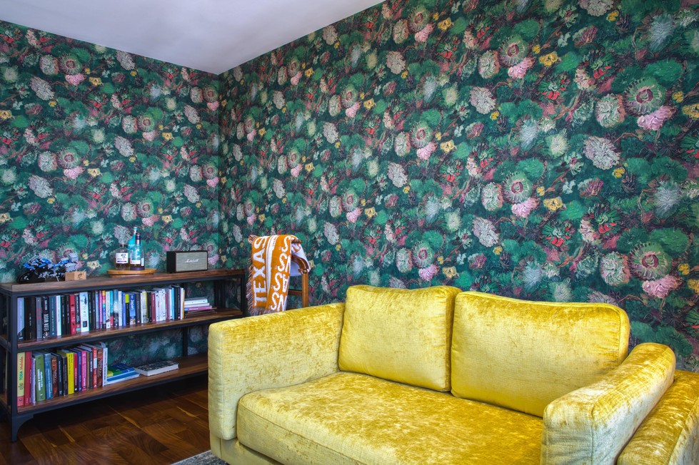 a yellow couch in front of a wall with texas on it