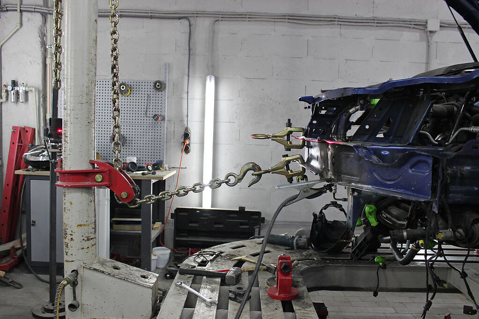A bent chassis being pulled and straightened.