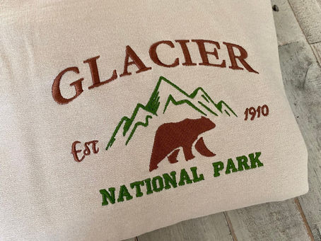 Discover the Majesty of Glacier National Park with Our Embroidered Crewneck