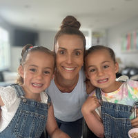 Mom and twin daughters smiling